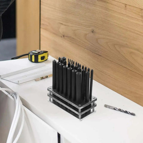 28 Piece Cylindrical Steel Punch Set With Positioning Punches for woodworking and jewelry crafting on a workshop table