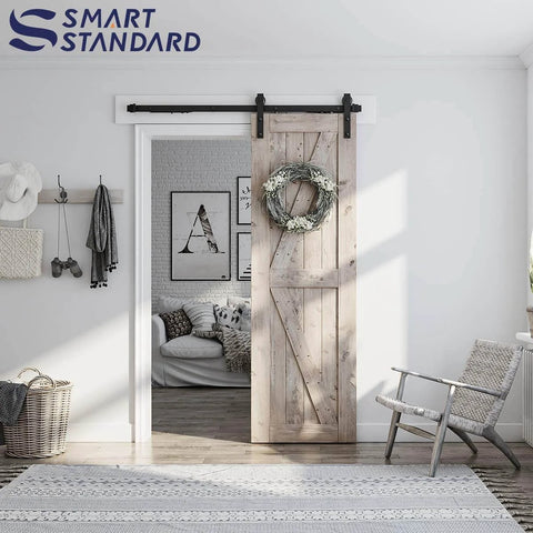 Sliding Barn Door Hardware Kit With Soft Close For 5 To 10 Ft Doors installed on wooden door in living room