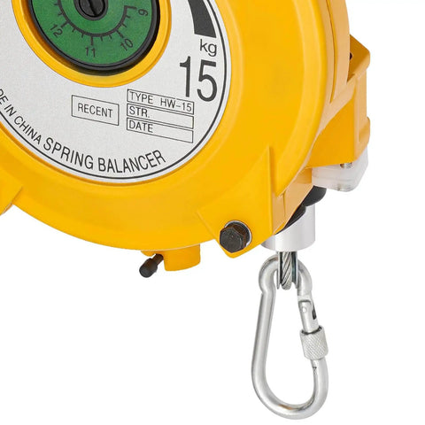 Close-up of a yellow retractable spring balancer with 15 kg gauge and hook; part of the Retractable Spring Balancer For Tools With Adjustable Tension From 19.8 To 33.1 Lbs Pro Grade Tool Fixture Holder With 1.5 Meter Wire Rope And Easy Gauge Dial Built For Garages And Shops Heavy Duty Industrial Settings.