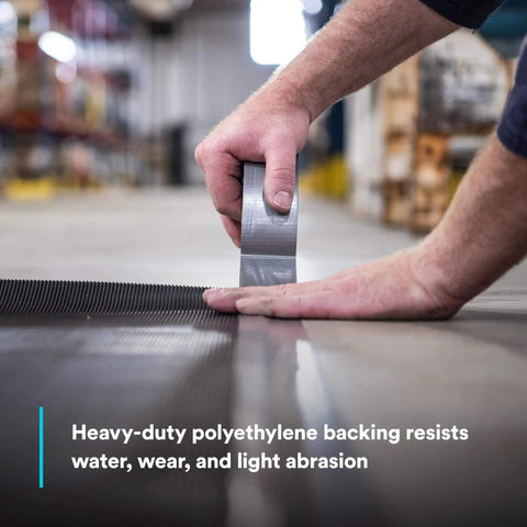 Applying Heavy Duty Duct Tape DT11 Silver 48 mm x 54.8 m (11 mil) on industrial surface, showcasing strength and adhesive grip