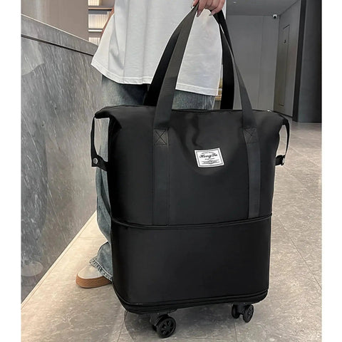 Rolling Duffle Bag With Detachable Wheels For Travel, black durable tote with easy grab handles, shown with wheels attached on floor