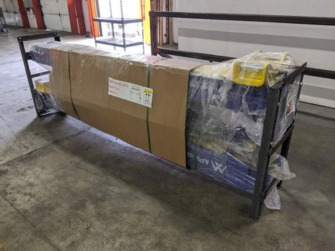 APlusLift HW-10KBP 10,000 lb two-post car lift on metal frame, boxed with green straps and shrink wrap