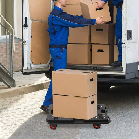 Mover using Interlocking Flat Dolly Set With 360 Degree Wheels For Heavy Furniture to transport boxes near a van, Black.