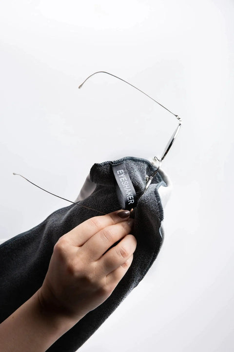 Hand using Premium Microfiber Glass Cleaning Cloth 30x20 Cm for Glasses Phone Screens on eyewear lens