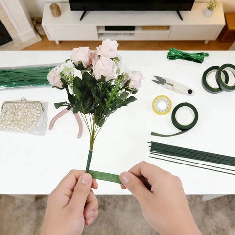 Hands wrapping flowers with tape from Dope DIY Floral Craft Kit With ABS Pearls, Metal Wire, 2mm Flower Stems, Scissors, Pliers