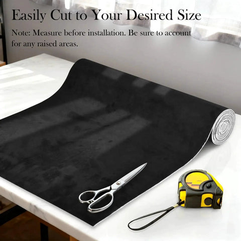 Black suede headliner fabric with foam backing rolled out on table, scissors, and measuring tape, size 96x60 for auto interiors.