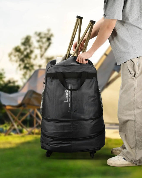 Person holding Expandable Rolling Duffel Bag With Spinner Wheels Lightweight Collapsible Luggage 55L-113L in outdoors setting