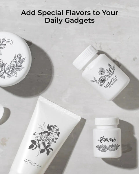 Assorted skincare products with floral designs including a tube, jar, and bottles on a light surface.