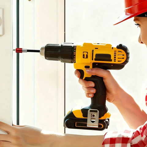 Cordless drill, yellow with black grip, side view with bit in chuck held by hand.