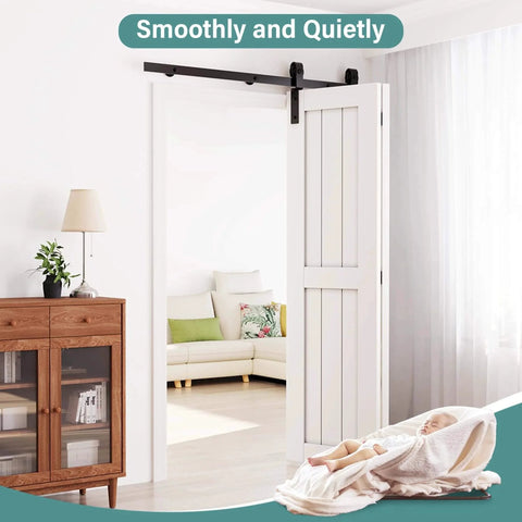 White door with Carbon Steel Bifold Barn Door Hardware Kit For 32 Inch Closet Doors 3ft Track Smooth Quiet Black installed.