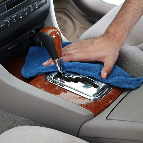 Person cleaning car interior with 90 Pack Blue Cotton Shop Towels 14 By 12 Inches Reusable Rags For Auto Garage Industrial And Home Cleaning.