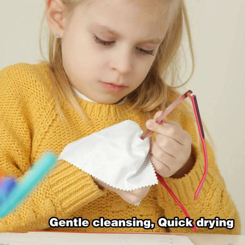 Child using Streak Free Eyeglass Lens Wipes with microfiber cloth to clean glasses, close-up view