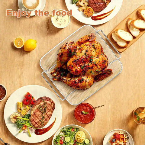 Roasted chicken on Replacement Air Fryer Basket For Emeril Lagasse 26 Qt French Door Oven 360, surrounded by dishes on a table.