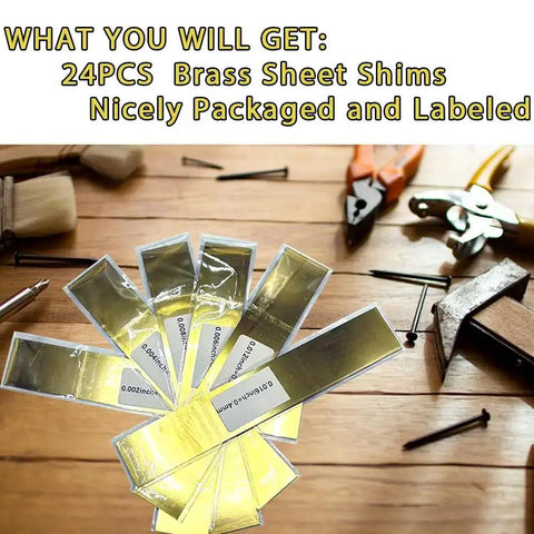 24 brass sheet shims displayed on a wooden surface with tools, highlighting the labeled and packaged 12 Piece Brass Shim Stock Assortment 6 By 1 Inch For Leveling, Gap Filler, And Trim Fitment, Includes Six Thicknesses From 0.002 To 0.016 In For Diy Projects And Industrial Use.