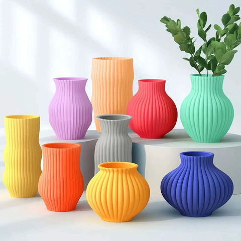 Assorted colorful 3D printed vases showcasing design versatility with Premium PETG Filament 1.75mm 2kg 3D Printer Filament Bundle.
