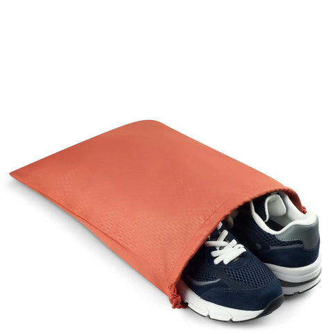 Pair of sneakers inside an orange protective pouch