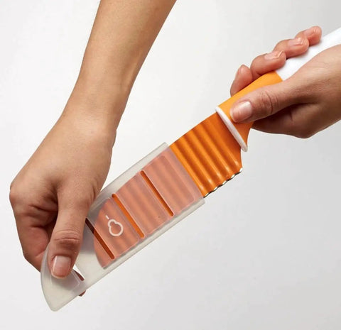 Stainless Steel Crinkle Cut Knife Wave Slicer For Veggies And Potatoes Large Crinkle Cutter For French Fries Easy And Fast Crinkle Cuts With Soft Grip Handle And Safety Cover Dishwasher Safe in hand.