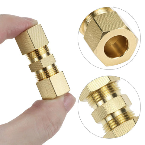 Brass compression tube fitting for 1/8–1/2 in OD tubing, hex nut style, shown held between fingers