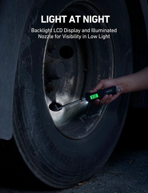 AstroAI digital tire pressure gauge with backlit LCD and stainless steel probe used on a car tire valve