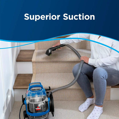 Pro Grade Portable Carpet And Upholstery Deep Cleaner For Stairs Rugs And Auto Interiors With 5.7A Motor 5ft Hose 3 In 1 Stair Tool Tough Stain Brush And Hydro Rinse Self Clean System BISSELL being used on stairs.