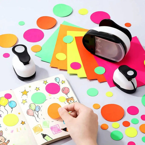 Three Piece Circle Punch Set 2 Inch 1 5 Eighth Inch And 1 Inch Black Paper Punches with colorful sticker papers used for DIY albums.