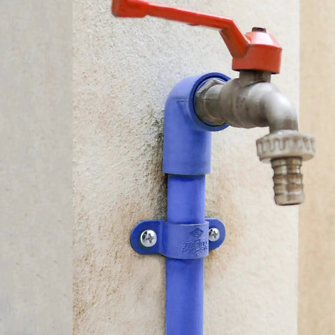 Outdoor water faucet attached with All In One Concrete Anchors And Screws Kit For Masonry Projects on a cement wall.