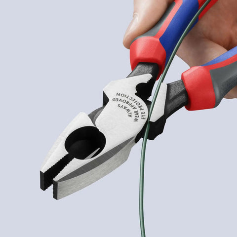 Close-up of Ultra High Leverage Linemans Pliers with Fish Tape Puller and Crimper 9.5 Inch, cutting green wire