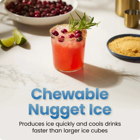 Chewable nugget ice in a red cocktail glass with rosemary and cranberries, sugar rim on a white countertop.