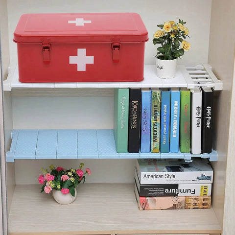 Rock Solid Metal First Aid Box With Safety Lock, red, on shelf, next to books and flowers