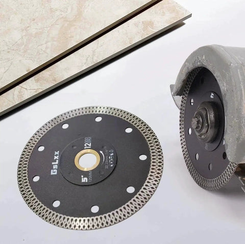Diamond saw blade beside a ceramic tile, with Brass Arbor Reducer Bushings 1 Inch To Five Eighths Inch installed on the saw.