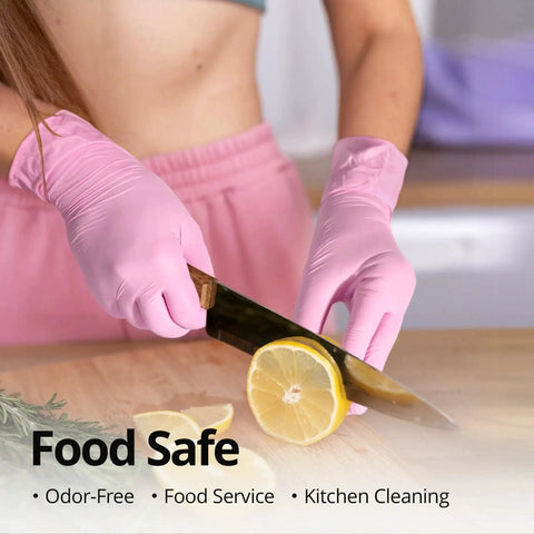 Person wearing Pink Nitrile Gloves 3 Mil Latex Free Powder Free for Cleaning 100 Count cutting lemon