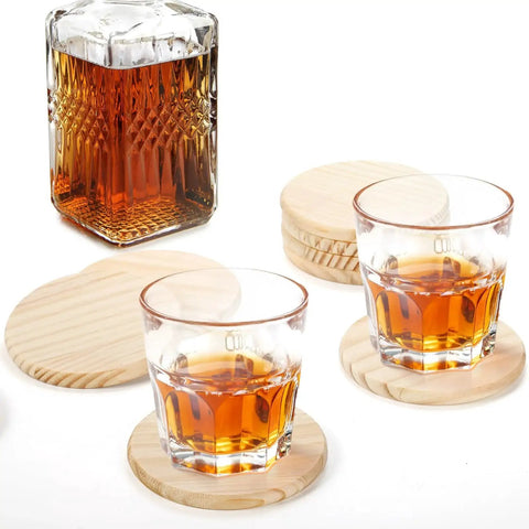 Unfinished Wood Coasters Set 24 Round 4 Inch Blank Drink Coasters With 96 Non Slip Foam Knots next to glasses and a bottle