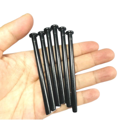 Hand holding Six Pack 4 Inch Interior Door Hinge Pins For Replacement Doors With Oil Rubbed Bronze Finish And Black Color Option Includes Screws Easy Install Durable Steel Pins For Smooth Quiet Door Closing By ZDingTech