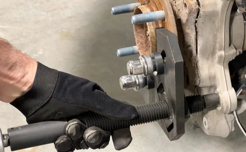 Hub Remover Tool For Frozen Hub Assemblies Fits Most 5, 6 And 8 Lug Hubs On Cars And Trucks With 1/2 Inch Driving Plate in use
