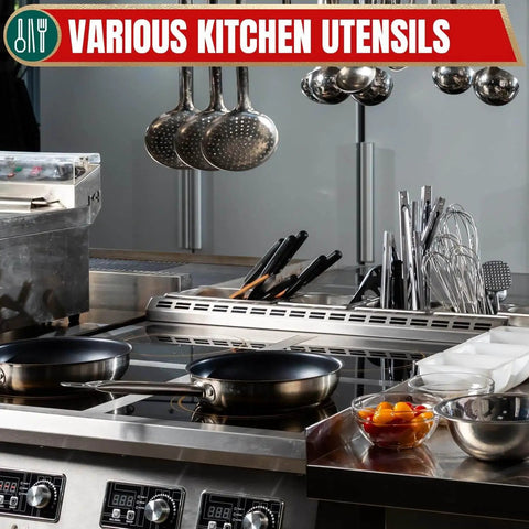 Modern kitchen with various utensils and cooking pans on a stove.