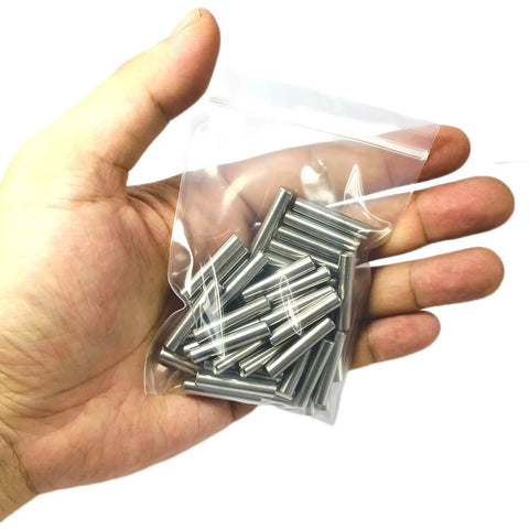 Hand holding a bag containing 5mm x 25mm Metal Dowel Pins 50 Pack For Wood Furniture And Shelves