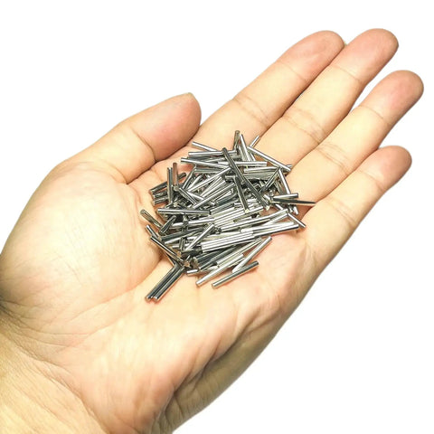 Hand holding 100 Pack 2mm By 20mm Dowel Pins Metal Dowel Pins M2 For Wood Furniture Shelves 304 Stainless Steel Shelf Pegs Bunk Bed Pegs