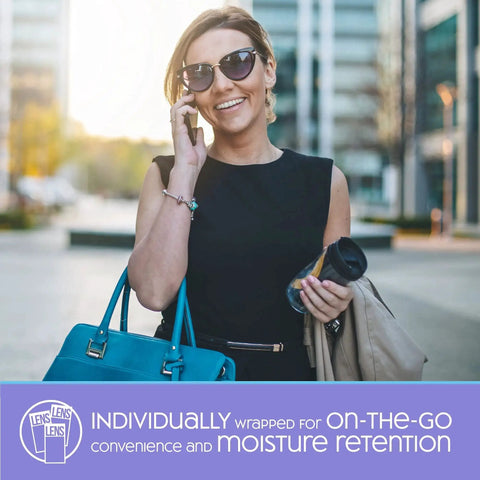 Woman using SmudgeGuard Lens Wipes 100 Count For Glasses Cameras Non Scratching while holding a phone and bag outdoors