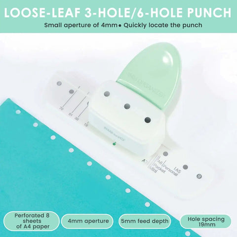 Three-Hole Mini Paper Puncher Portable Desktop Handheld Puncher placed with turquoise paper, showcasing ABS design and hole spacing.