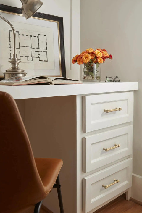Faircrest Champagne Bronze Cabinet Pulls on white drawers, 5-1/16 inch spacing, transitional style for modern decor