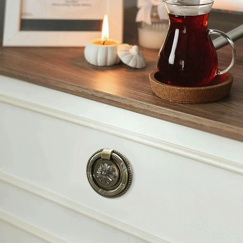 Vintage Oil Rubbed Bronze Ring Pulls for Cabinets and Drawers, 2 Inch Diameter, shown on white dresser with candle and drink