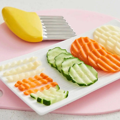 Crinkle Cutter Wave Slicer For Potatoes And Veggies Durable Stainless Steel Fry Cutter For French Fries Chips Carrots And More with cut vegetables on a plate