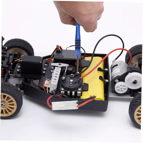Hand using screwdriver from Pro Grade All In One RC Car Repair Tool Set With Assorted Screws Bolts Nuts And Fasteners Kit on RC car