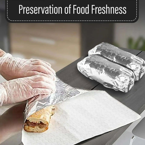 Hands wrapping sandwich in 14 By 16 Inch Aluminum Foil Sandwich Wrap Sheets 100 Pack Heat Resistant Insulation Paper For Sandwiches