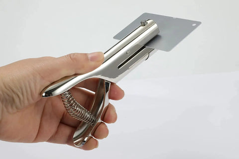Hand holding Beefy Heavy Duty 1/8 Inch Single Hole Punch With Ultra Long Depth Up To 53mm, punching a card
