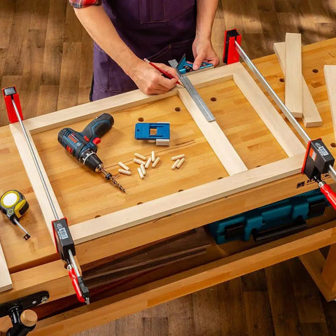Woodworker using 3/8 Inch Doweling Jig Kit With Drill Bit And Stop Collar, Dual Edge Stops for Easy Alignment on workbench.