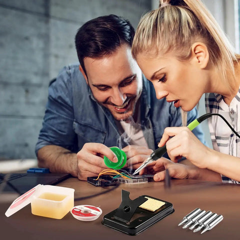 Two people using 100W LED Digital Soldering Iron Kit With Ceramic Heater, Quick 15 Second Heat Up, showing solder wire and tips.