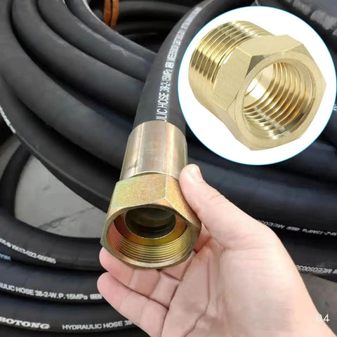 Hand holding Brass NPT Reducer Fittings Three Eighths Inch Male To One Quarter Inch Female Hex Bushing Pipe Adapter against hoses