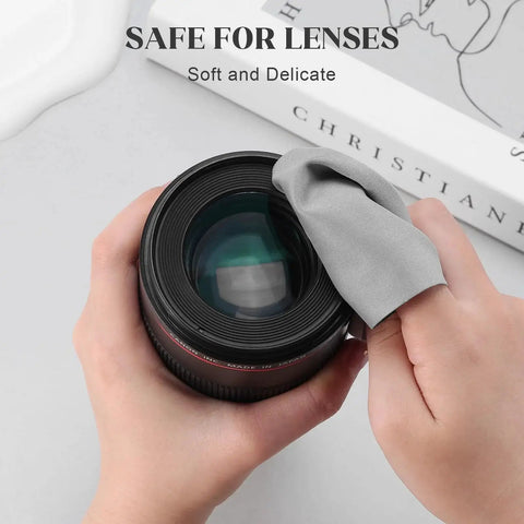Cleaning camera lens with a gray cloth from the 30 Pack Microfiber Cloths For Glasses And Electronics With 2 Lens Sprays.