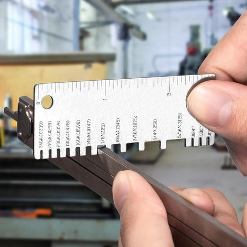 Close-up of a person using the Dual Sided Stainless Steel Wire Gauge Measuring Tool Set With 3 Pieces to measure metal thickness.